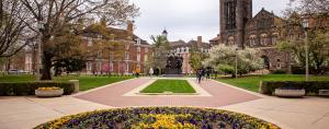 Alma Mater statue and flowers in the spring