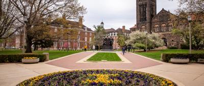 Alma Mater statue and flowers in the spring